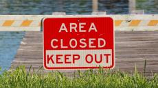 An image of a sign reading &#039;Area Closed - Keep Out&#039;