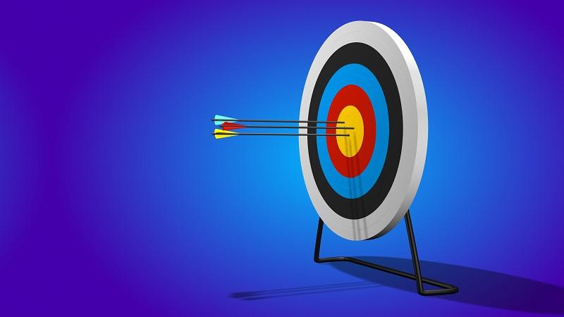 An image of an arrow lodged in the bullseye of a target