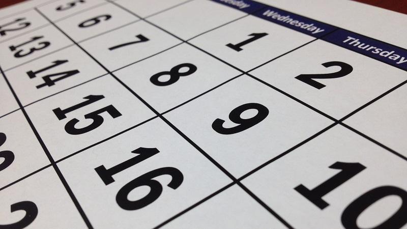 A close-up image of a calendar displaying dates in columns of weekdays