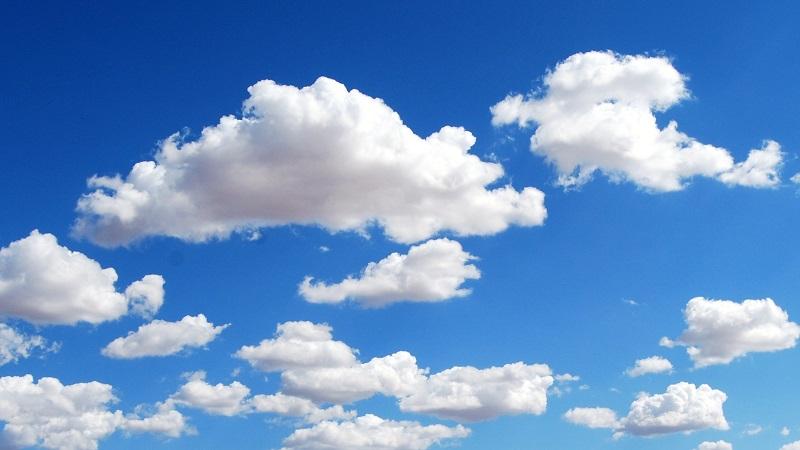 An image of white clouds against the background of a blue sky