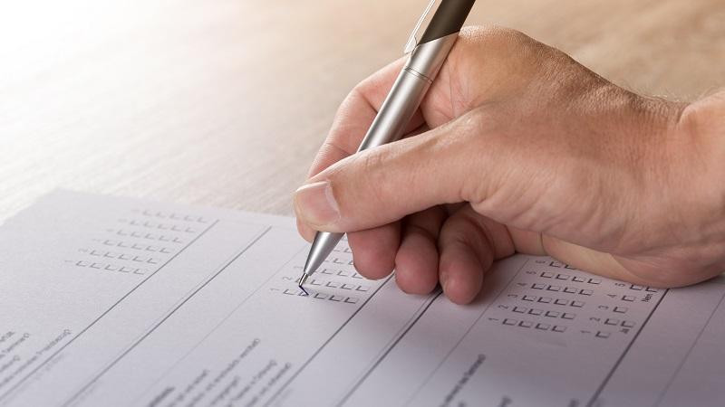 An image of someone completing a survey questionnaire