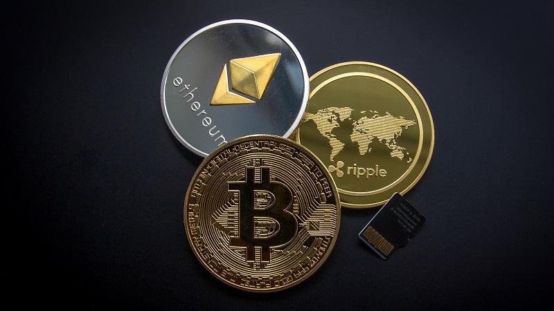 An image of the logos of cryptocurrencies displayed on coins