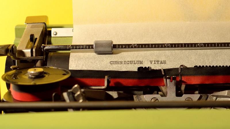 An image of a typewriter with a piece of paper reading &#039;curriculum vitae&#039;