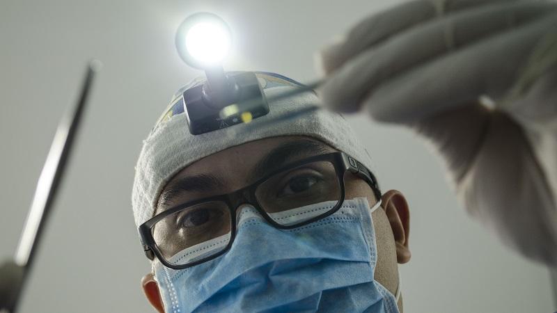 An image of a dentist looming over the camera