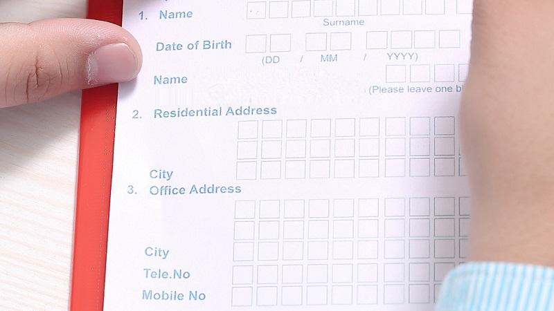 A close-up image of someone filling out personal details on a form
