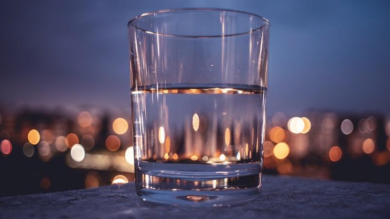 An image of a glass half-filled with water