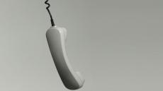 An image of a landline phone handset hanging by its cord
