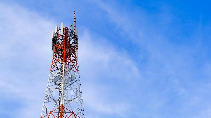 An image of a mobile communications mast with a blue sky in the background