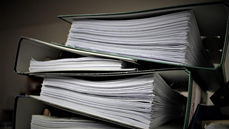A close-up image of several binders full of papers