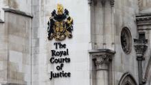 An image of a sign on the outside of the Royal Courts of Justice