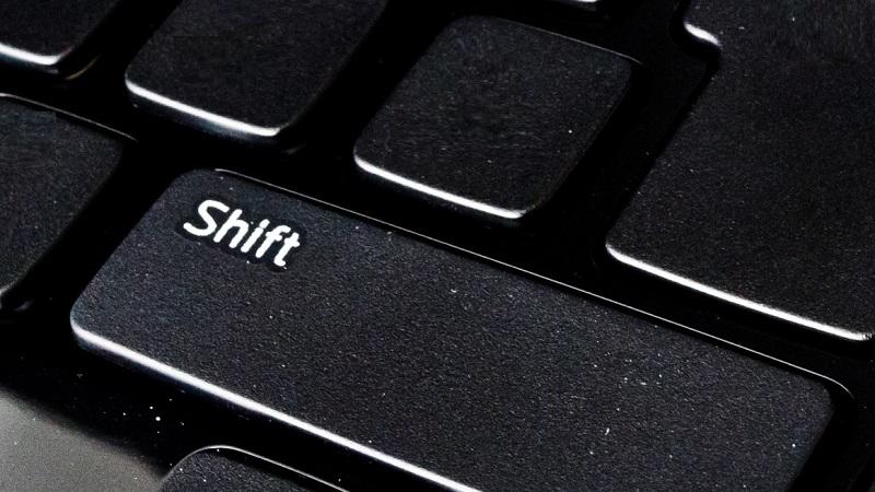 A close-up image of a &#039;Shift&#039; key on a keyboard