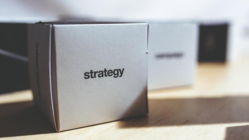 An image of a small cardboard box sitting on a table and labelled &#039;strategy&#039;