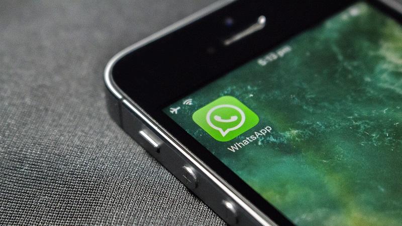 An image of the WhatsApp logo displayed in the top-left hand corner of a smartphone screen
