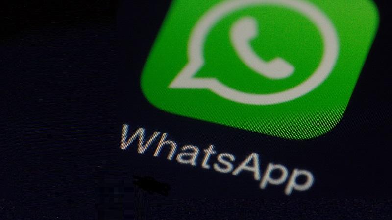 A close-up image of the WhatsApp logo displayed on a phone screen